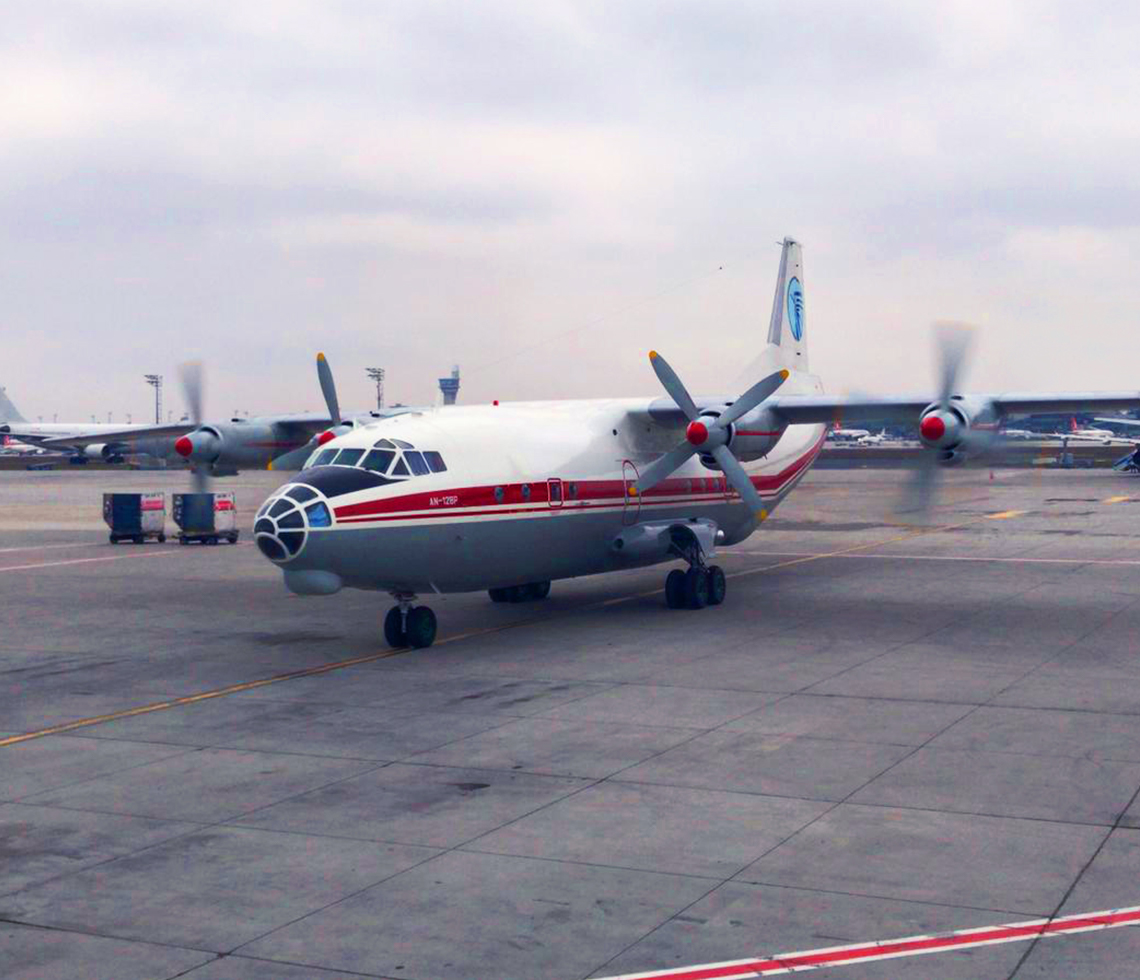 Antonov AN-12 cargo charter aircraft logistics on runway