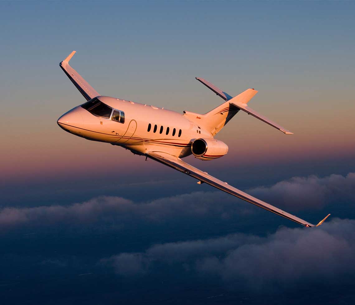 Hawker 850XP private jet flying during sunset