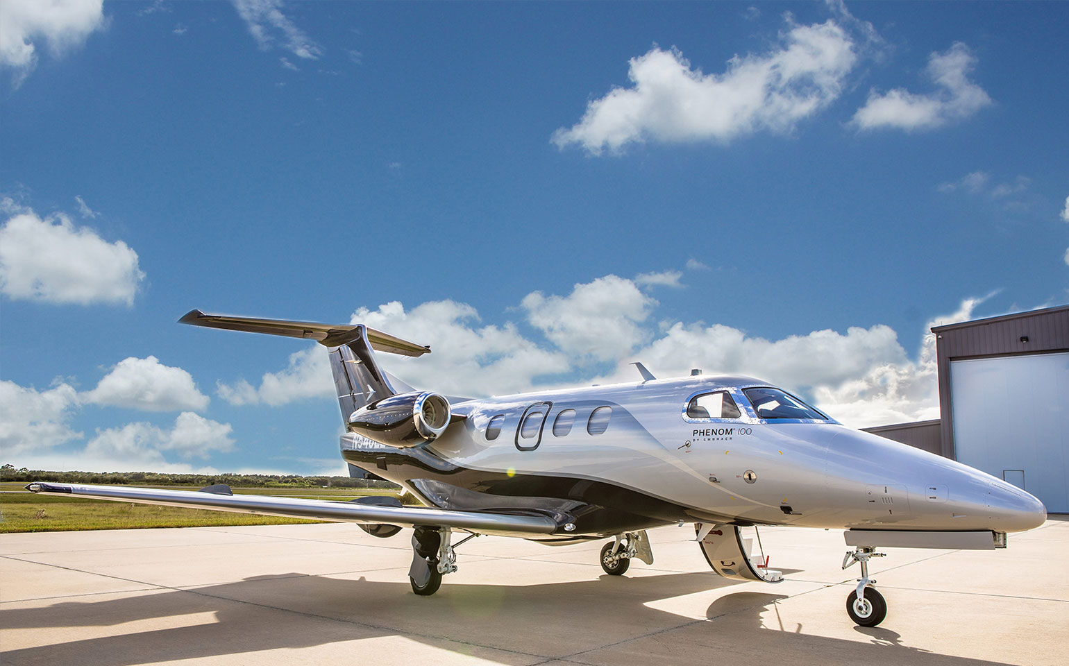 Embraer Phenom 100 parked at private jet hangar