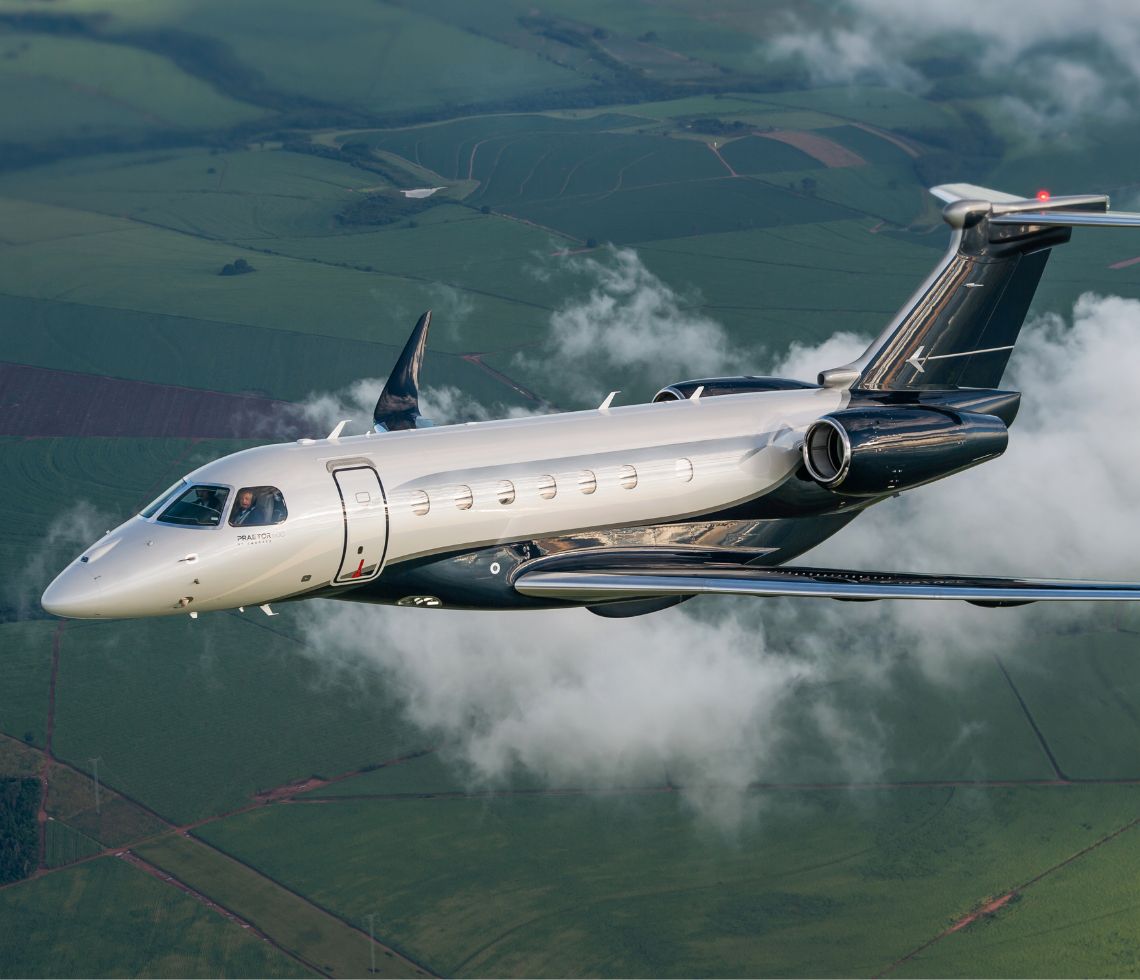 Embraer Praetor 600 private jet charter flying above clouds