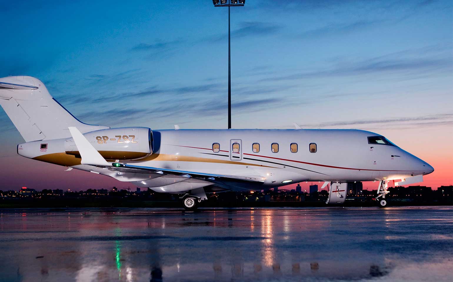 Bombardier Challenger 300 private jet charter on runway at dusk