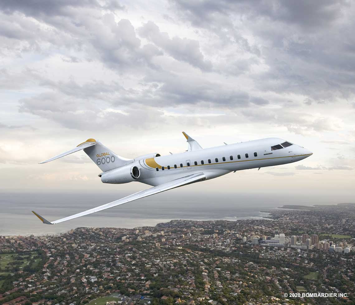 Bombardier Global 6000 private jet charter flight over coast