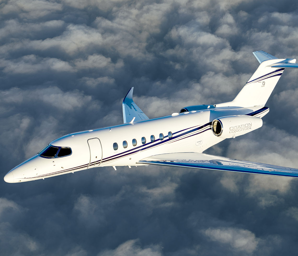 Cessna Citation Longitude private jet charter flight over clouds