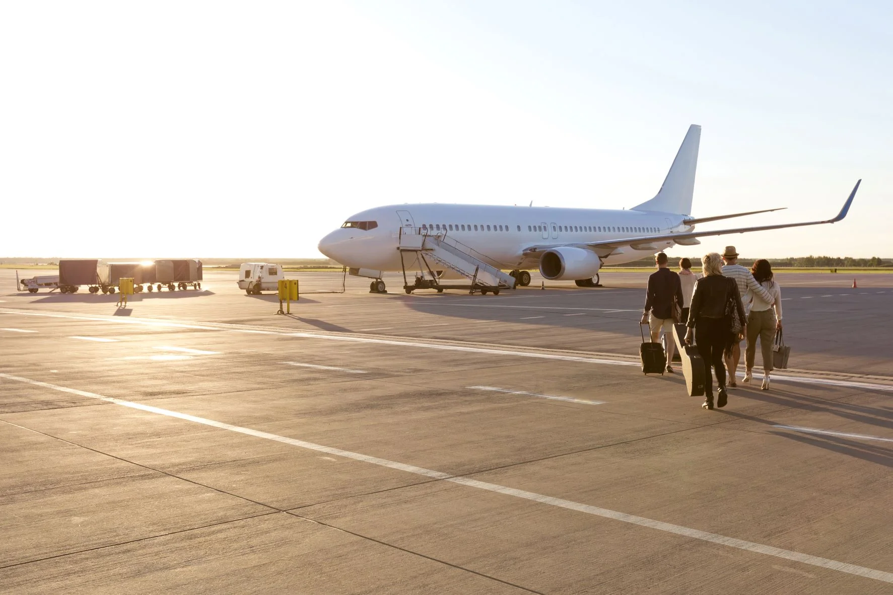 Group of people walking towards a plane